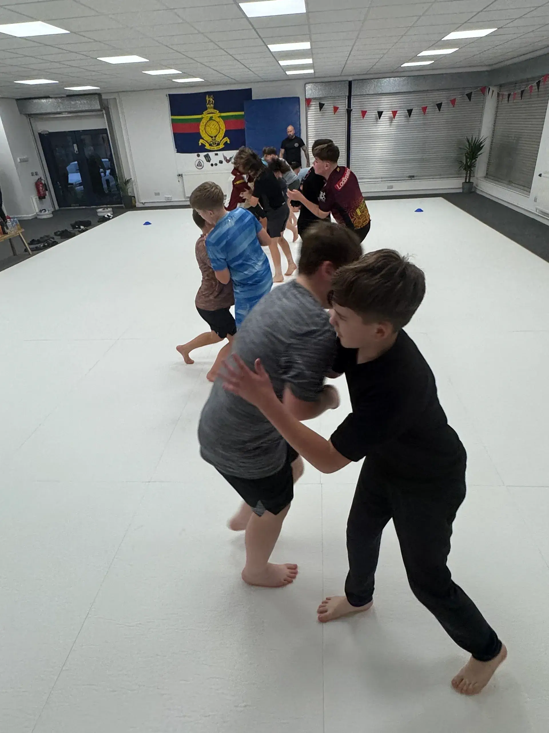 Children practicing martial arts in a dojo.